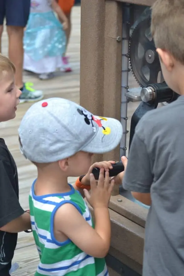 Children making pressed penny souvenirs at Disney World