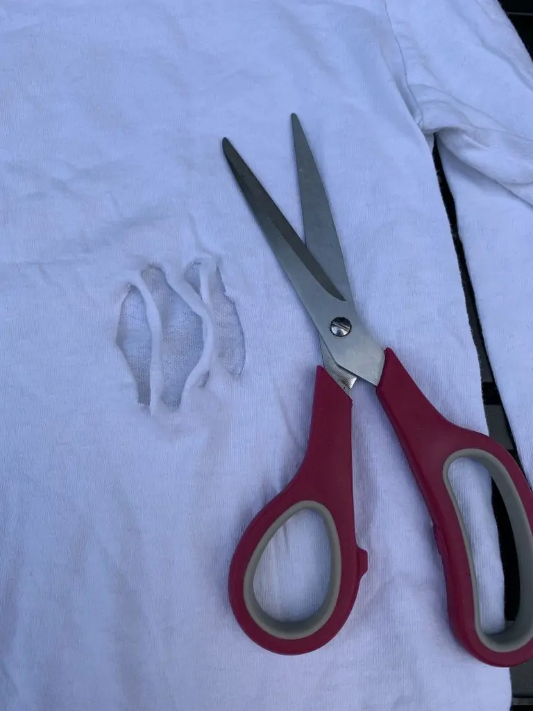 scissors and hole cut in shirt for zombie costume