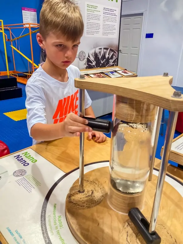 Boy playing with hands on activity at IMAG history and science center in Fort Myers, FL. A great option for families looking for things to do in Fort Myers.