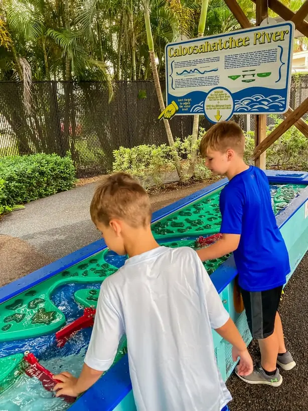 Boys playing in hands on water feature at IMAG history and science center in Fort Myers, one of our favorite things to do with kids in fort myers
