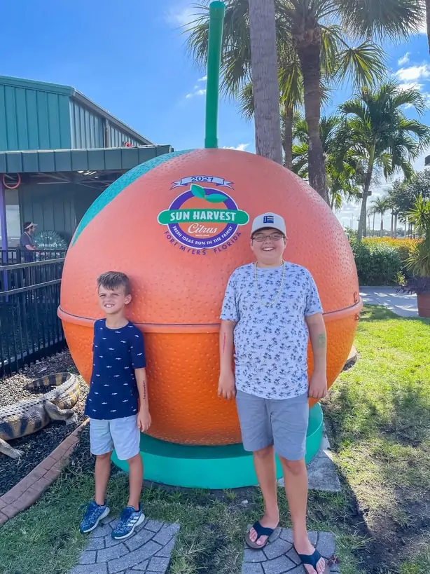 Kids standing in front of Sun Harvest orange in Fort Myers, FL