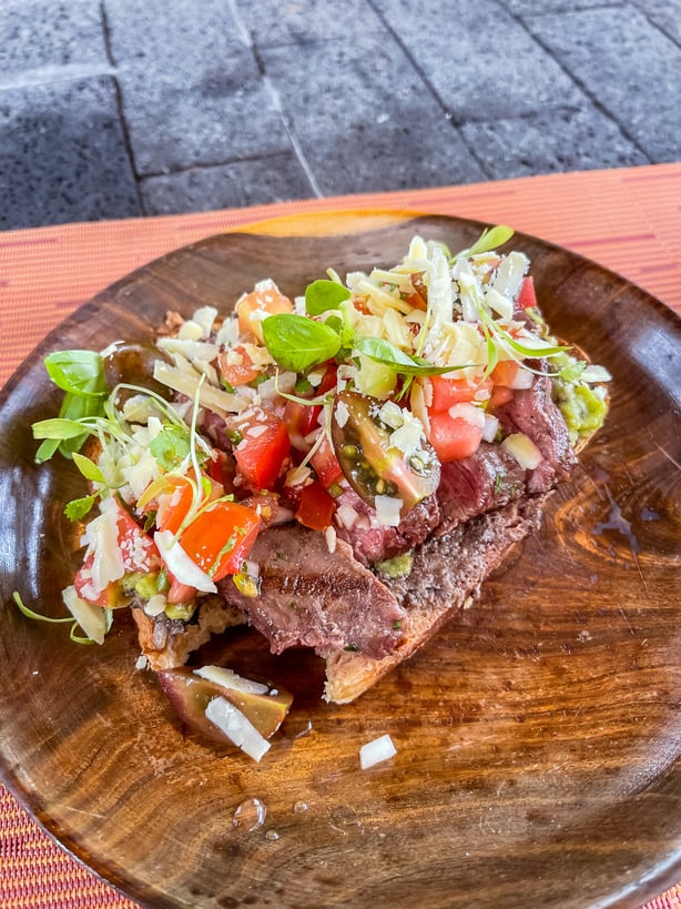 open faced steak sandwich at Amor Arenal pool bar