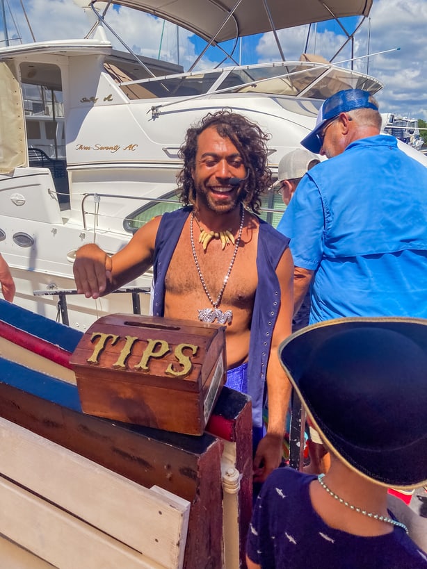 Pirate cruise Fort Myers crew member accepting tips for salty sam's pirate cruise