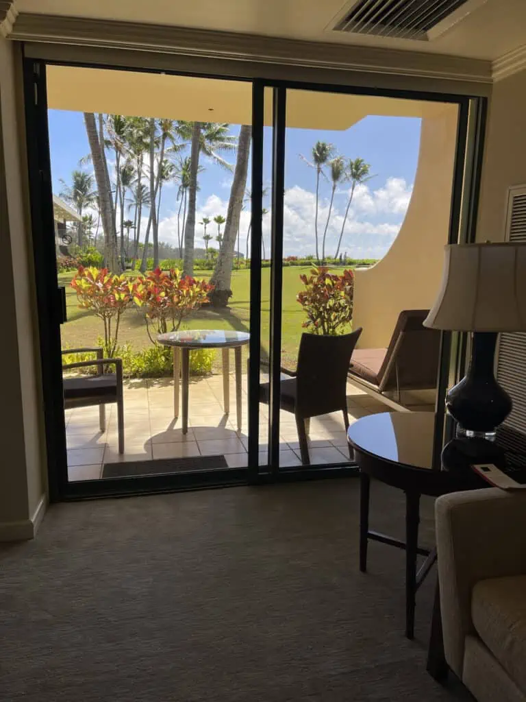 Garden view through sliding glass doors in standard suite at Grand Hyatt Kauai