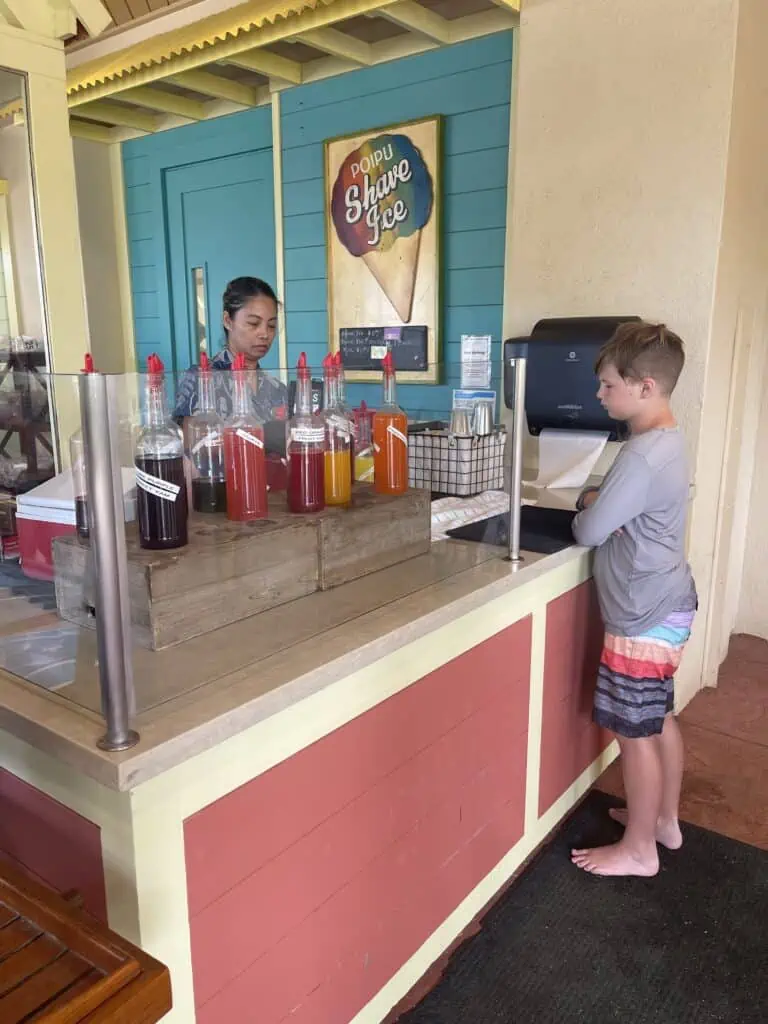 Boy getting shave ice at pool restaurant at Grand Hyatt Kauai.