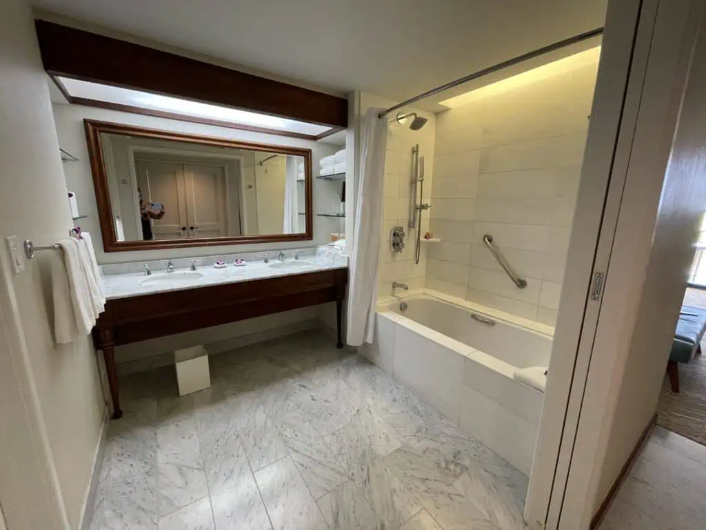 bathroom with vanity and tub in standard room at Grand hyatt kauai with points