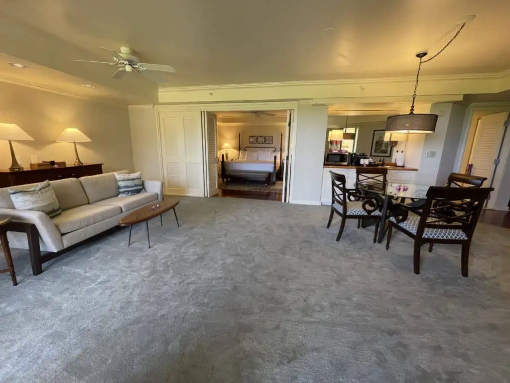 Standard suite living area with couch and 4 seat table at Grand Hyatt Kauai garden view suite